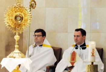 Seminarians Jeffrey Tomczyk, left, and Philip Maas assist during Adoration of the Blessed Sacrament in observance of World Day of Prayer for Vocations. 