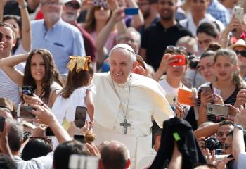 Pope Francis greets a girl during his general audience in St. Peter's Square at the Vatican June 13. (CNS photo/Paul Haring) 