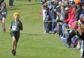 Diana Flynn, Holy Guardian Angels (HGA), Reading, is cheered on as she heads for the finish line to win the kindergarten, first- and second-grade girls’ race.  